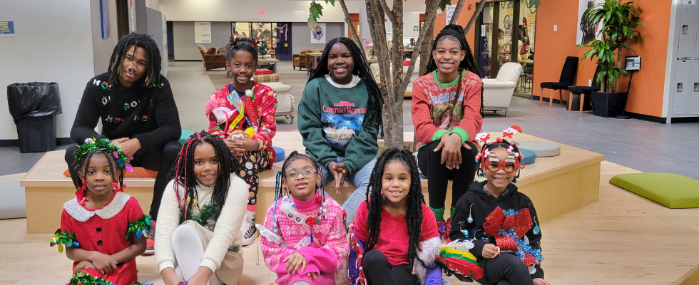 K-8 students posing in their ugly sweaters
