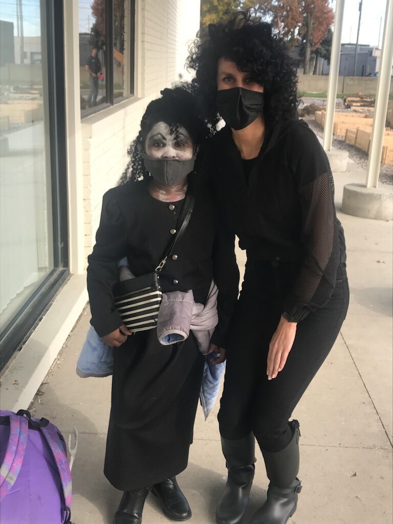 Ms. Mackenzie, 1st grade teacher, and student dressed up for Halloween